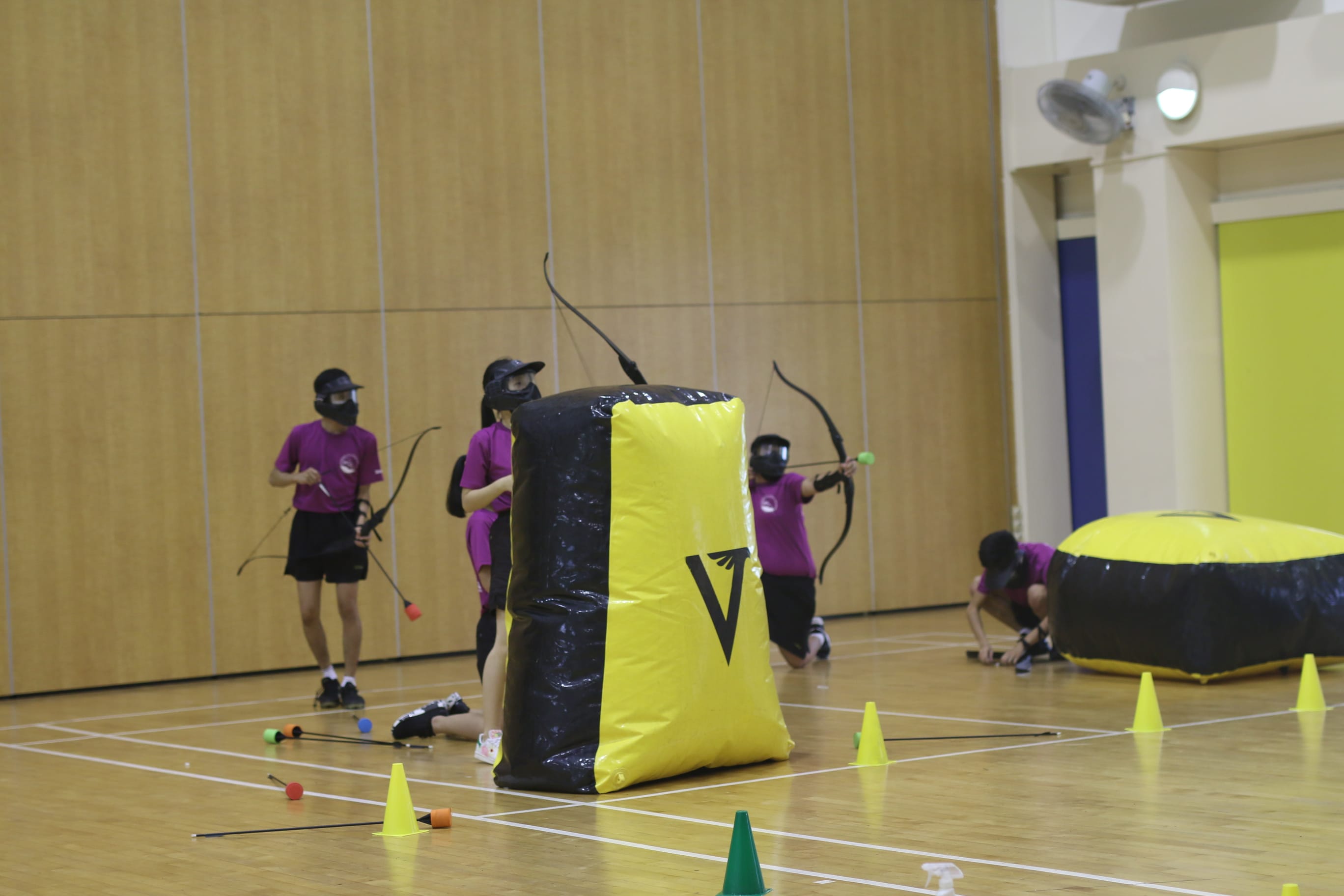 Sec 3 students engaged in archery tag indoors, as part of the BC week programme.